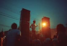 Hip-Hop Was Invented by a Jamaican Immigrant — and 6 Other Things the Caribbean Gave America llustration of a 1970s Bronx block party at dusk with stacked sound-system speakers and a DJ at a turntable - artist's interpretation by Wehpa, created with AI.