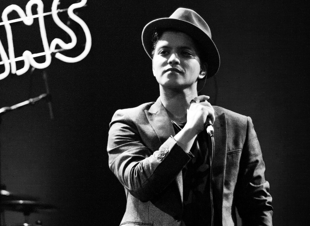 Bruno Mars performing on stage in 2010, black and white photo
