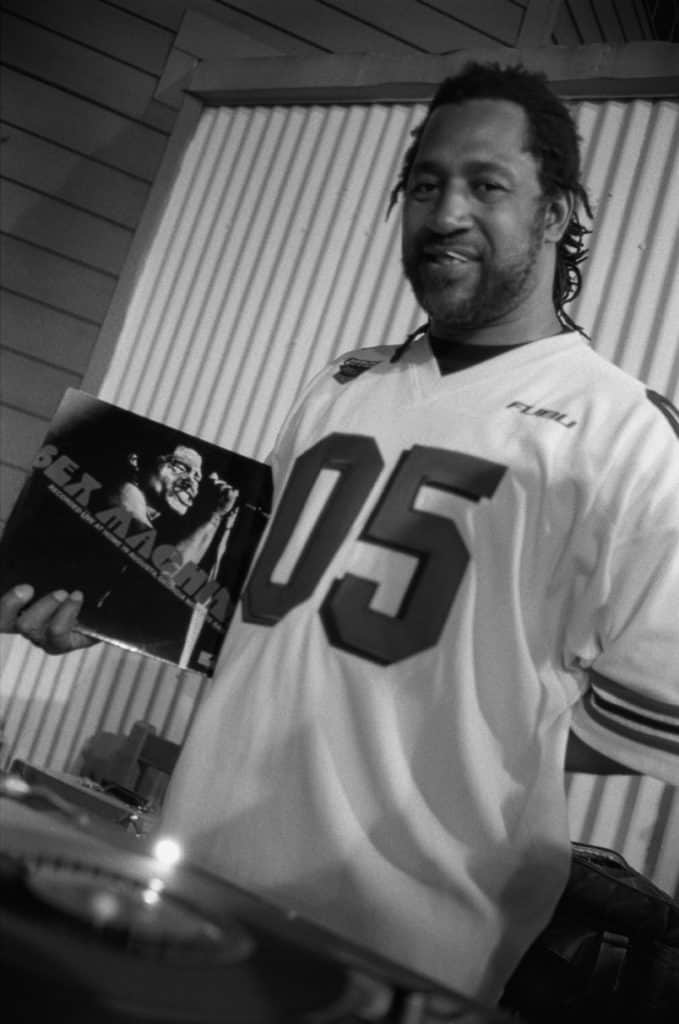 DJ Kool Herc holding a James Brown record, the Jamaican-born founder of hip-hop.