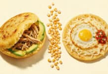 Are Arepas Venezuelan or Colombian? The Honest Answer Illustration comparing a thick stuffed Venezuelan arepa with a thin topped Colombian arepa, divided by a line of maize kernels